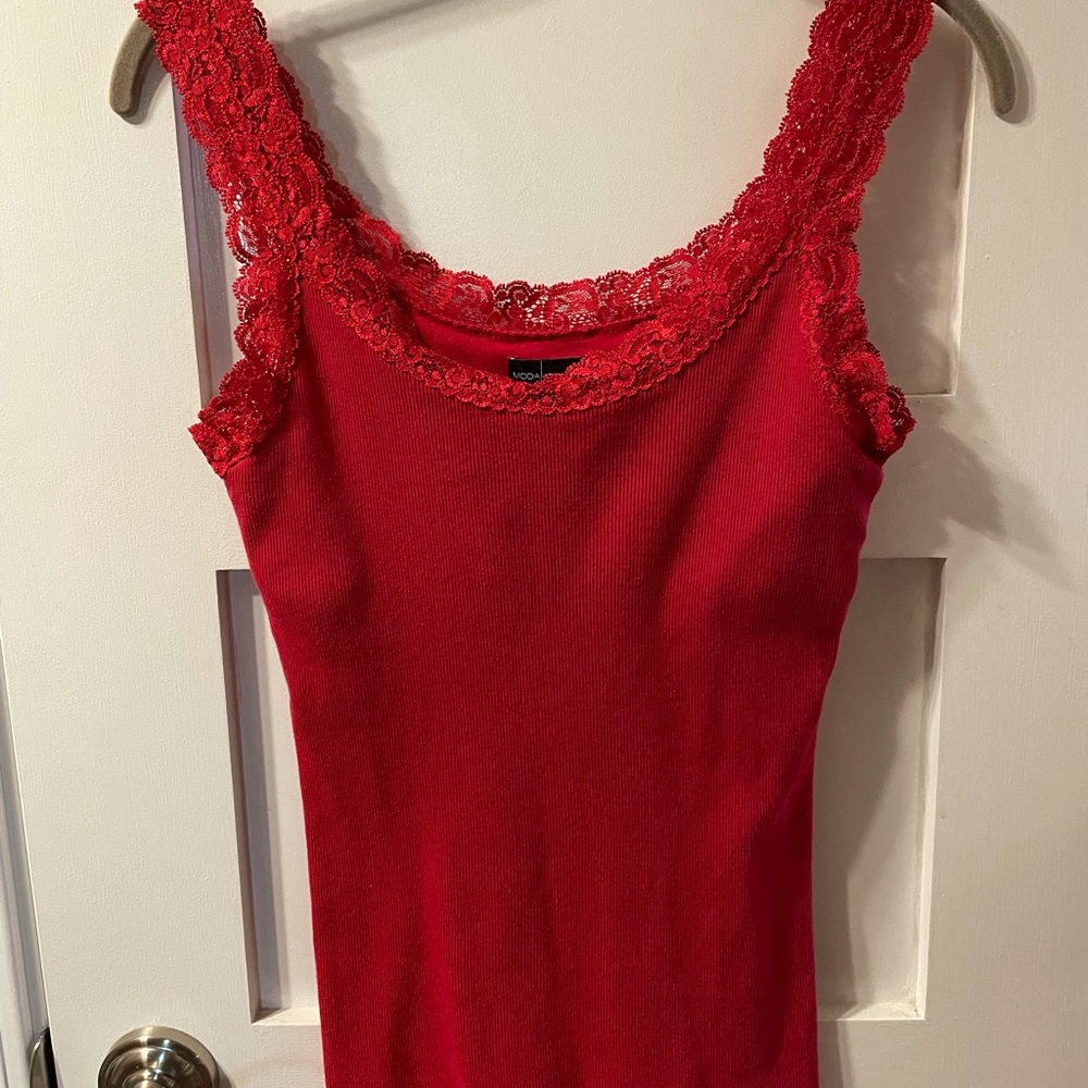 Red Moda International red tank top with lace neckline and straps.